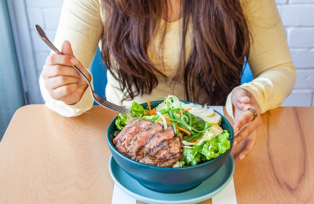 woman-eating-steak-salad.jpg